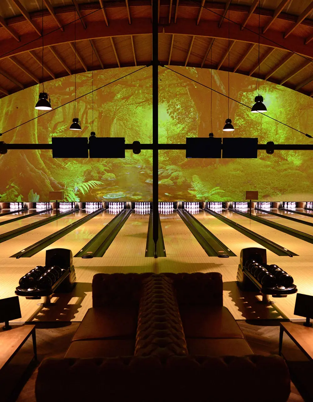 Bowling lanes with a forest in the background