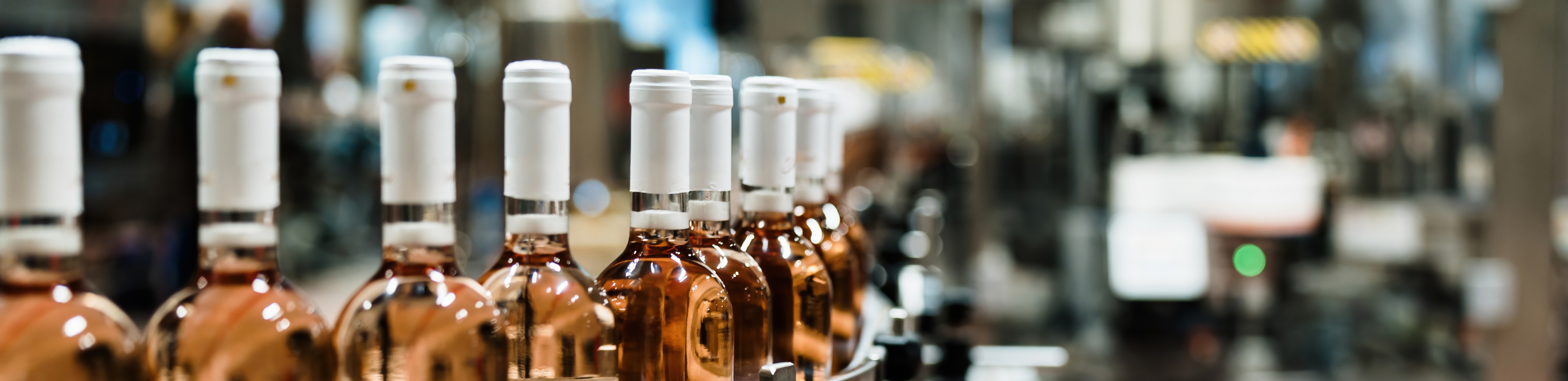 Bottles of wine on a conveyor belt in a wholesale distribution facility