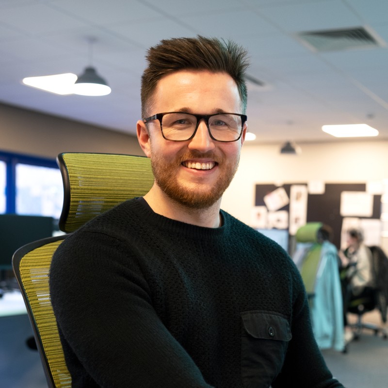 Richard McAuley headshot while sitting in his office