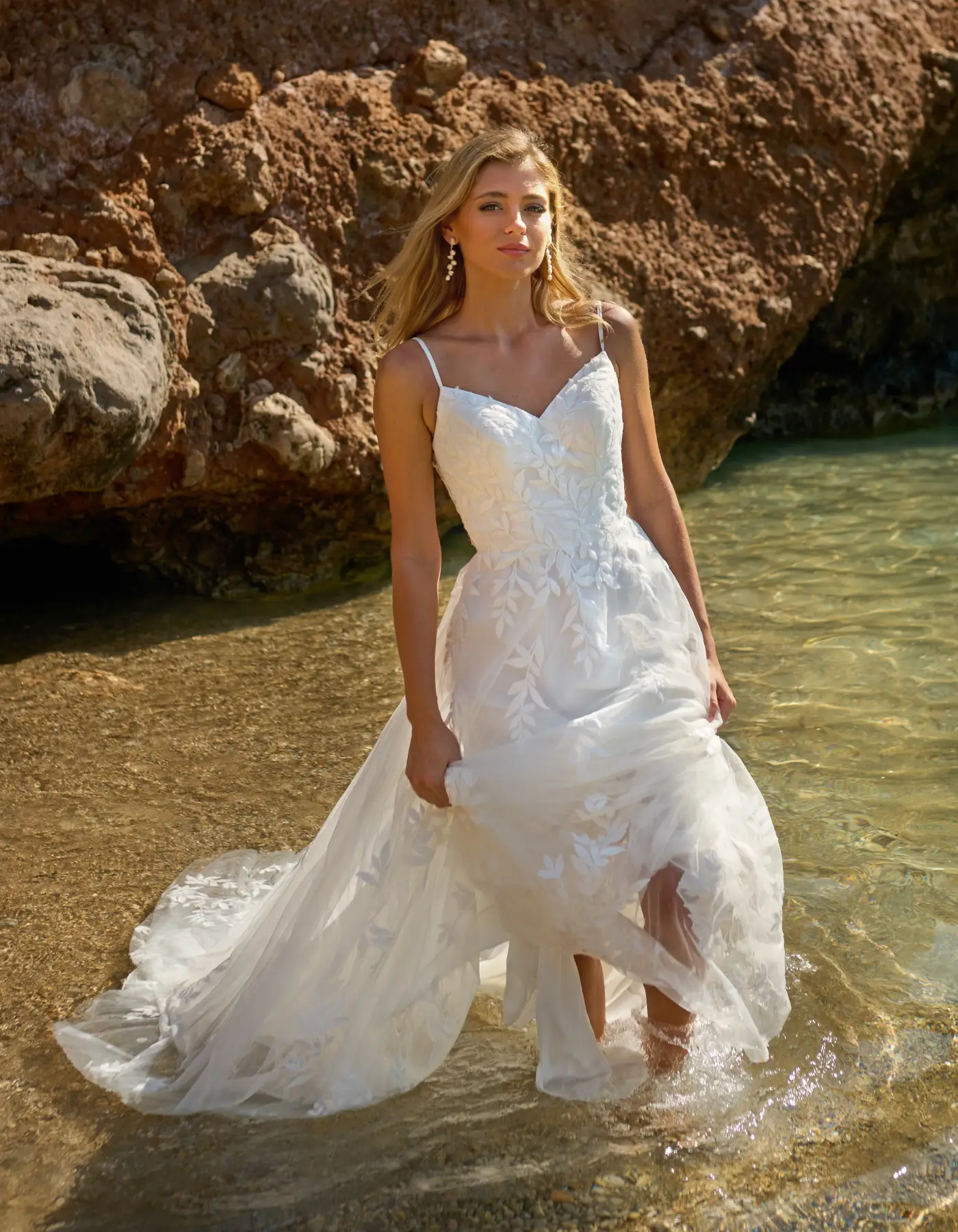 Bride walking through the sea in a WED2B wedding dress case study